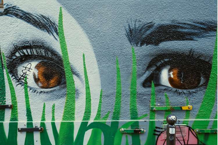 Graffiti art of eyes on a wall. Photo by Matt Seymour on Unsplash.