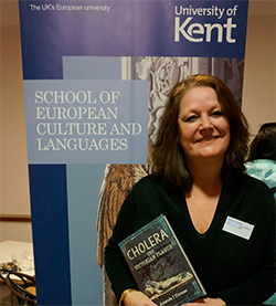 Author and SECL alumna Amanda Thomas holding a copy of her book 'Cholera: The Victorian Plague'