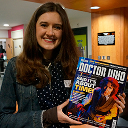 Linguistics graduate Emily Cook with an issue of Doctor Who Magazine