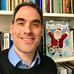 Chis Deacy in front of a copy of the Christmas Radio Times 2017 edition