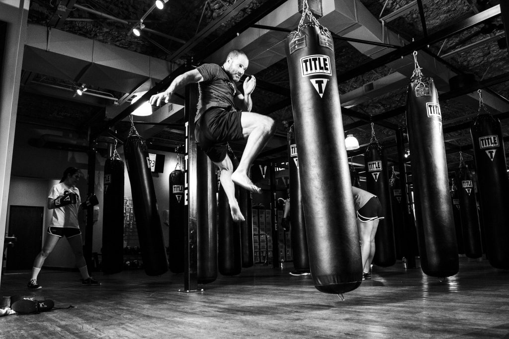 Kickboxer kicking a punching bag