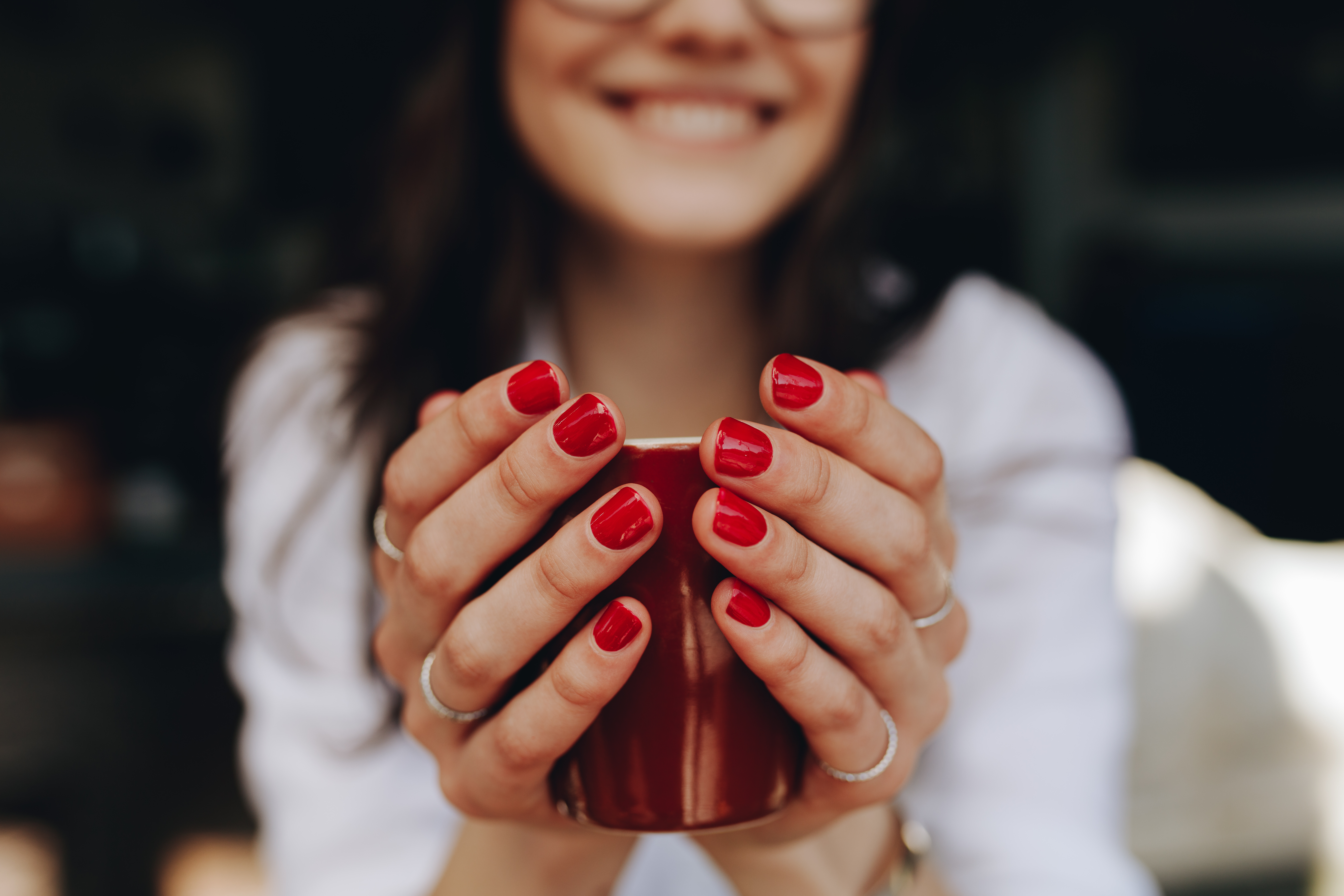Close up of woman hands holding a coffee cup.