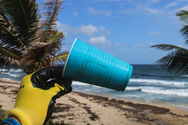 Plastic cup on a beach