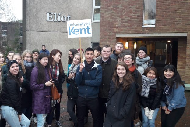 Group photo of students outside Eliot holding University of Kent sign
