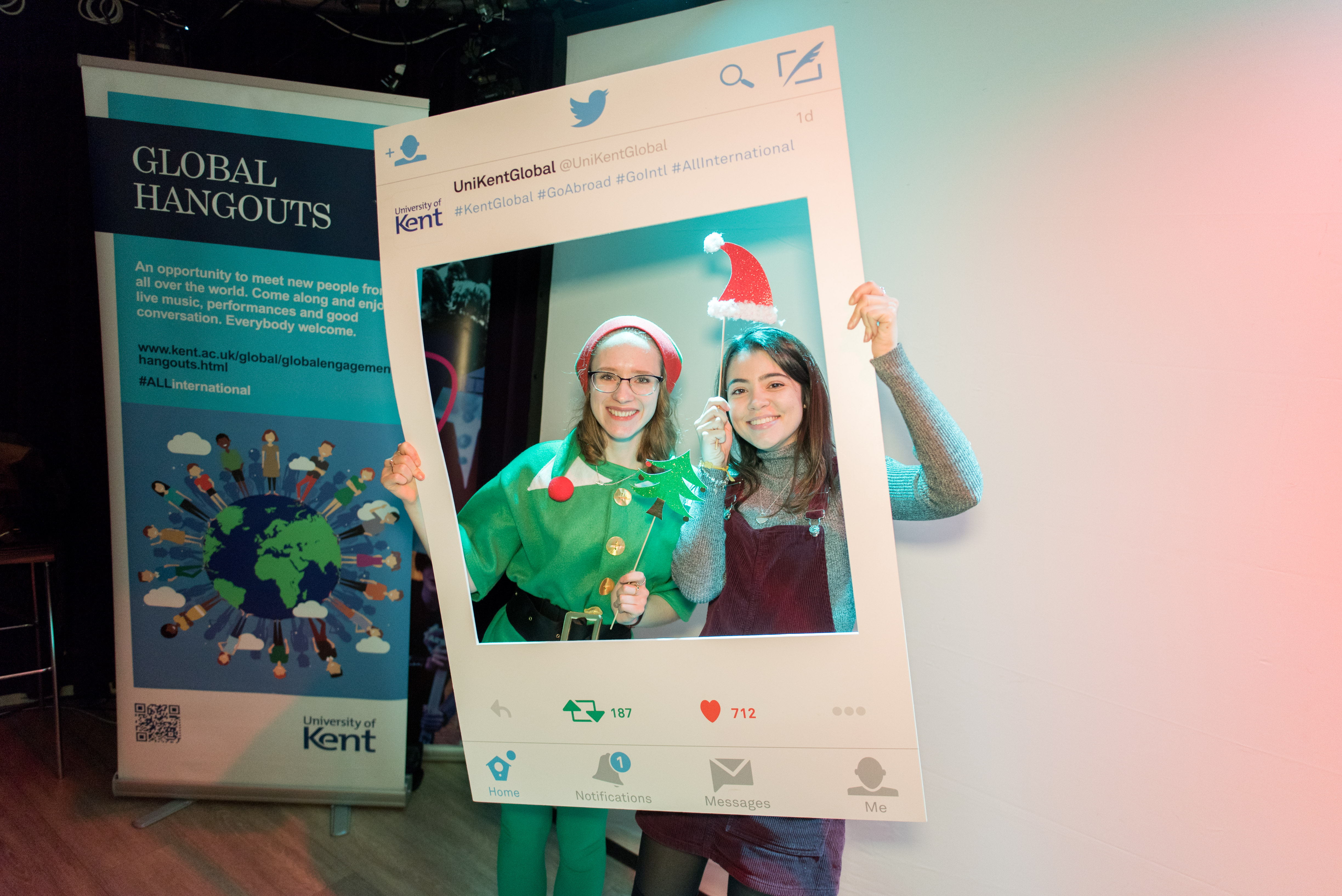 Students holding Global Hangoutphoto frame wearing festive outfits