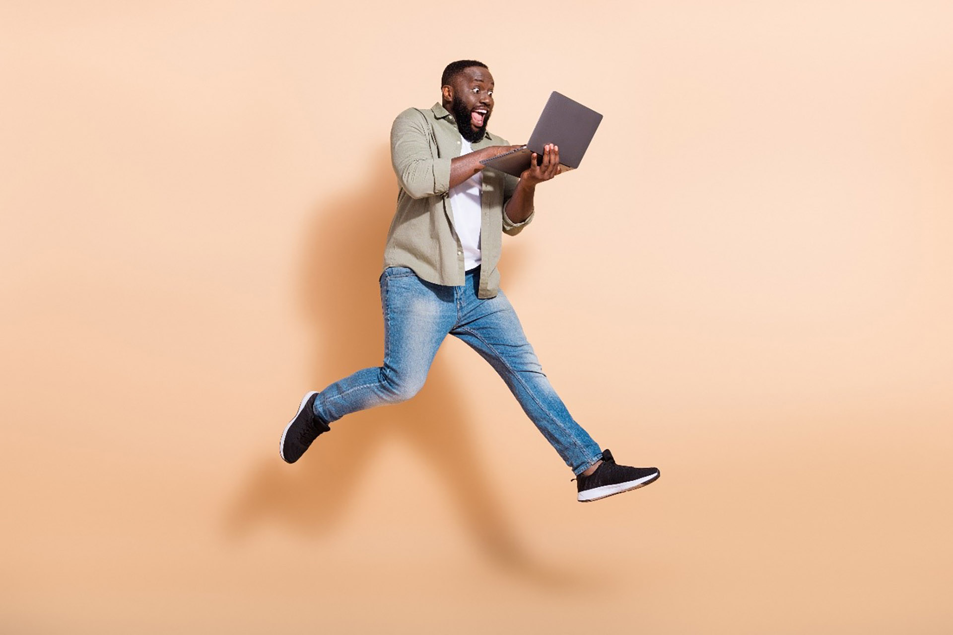 Man jumping in the air reading a book
