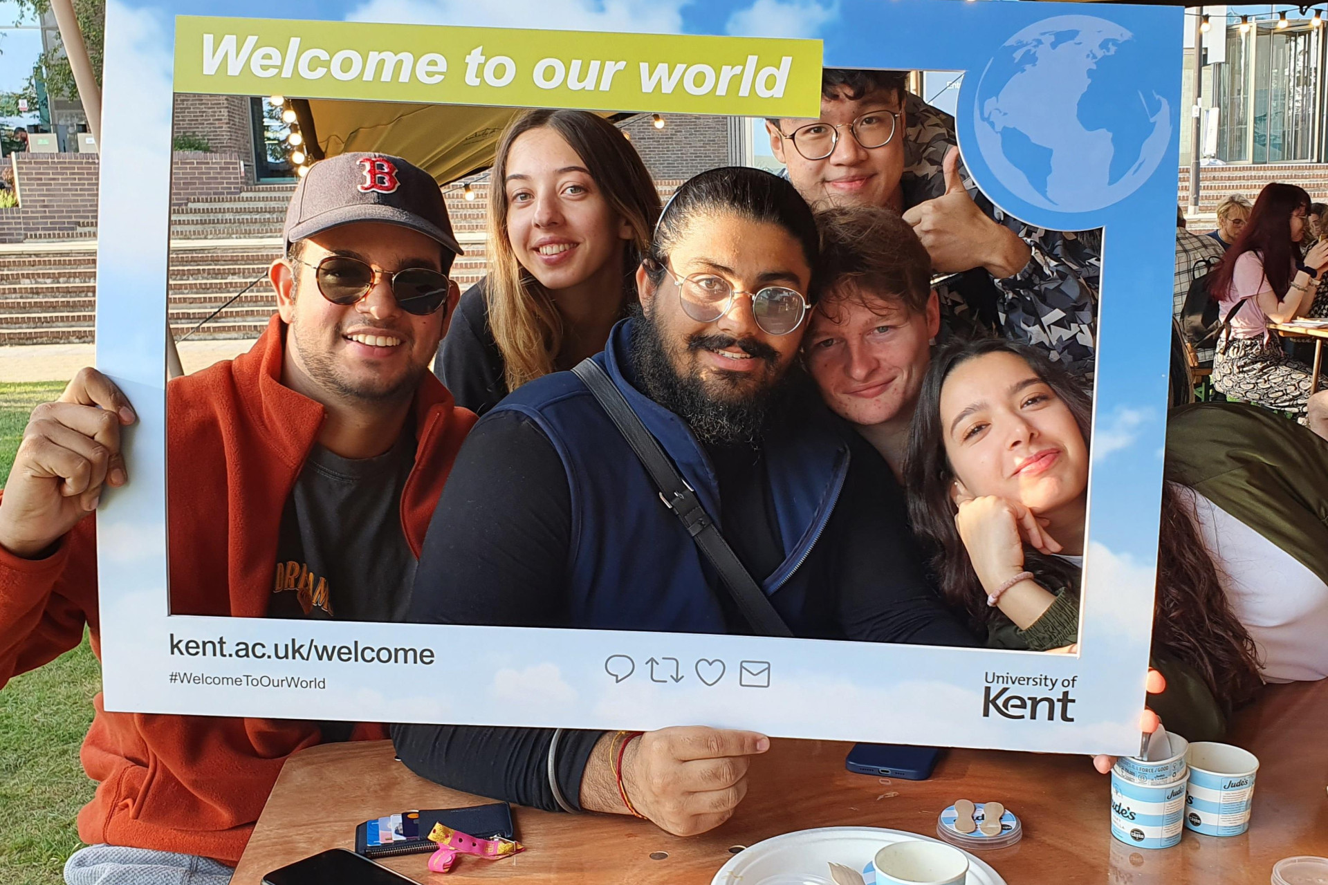 Students with Welcome to our World selfie photo frame
