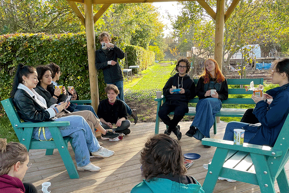 Students sitting together in Kent Community Oasis Garden