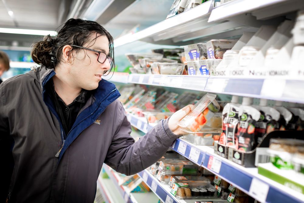 Student looking at food in co op shop