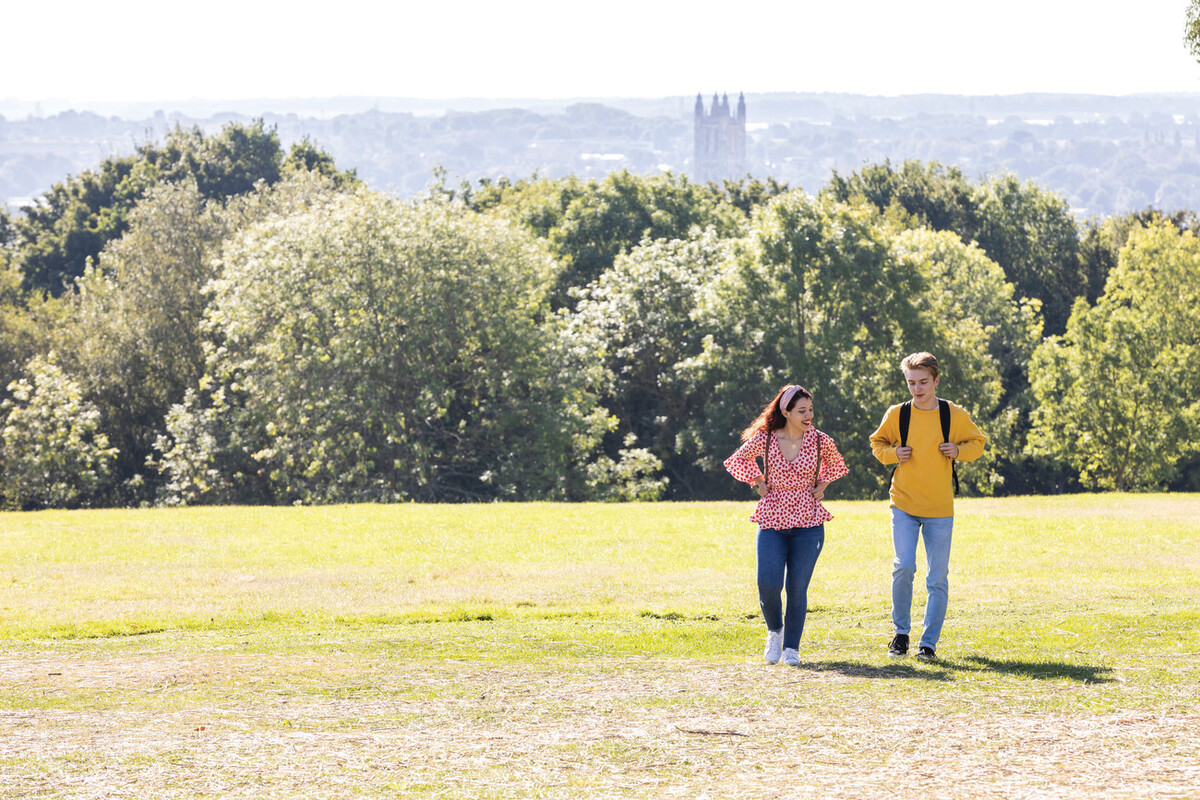 Students walking with Canterbury Cathedral in background
