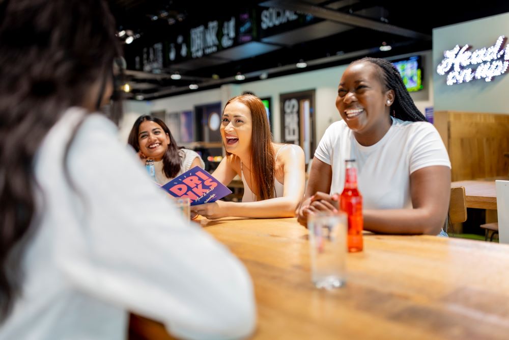 Students laughing together in a bar