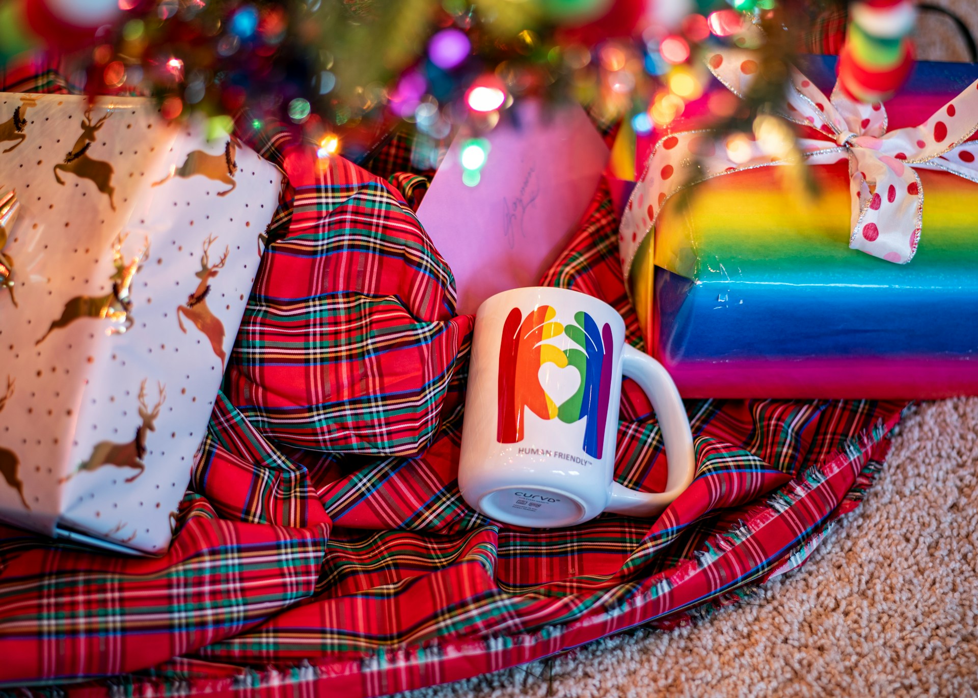 Christmas prsents with rainbow paper and a LGBT+ friendly mug