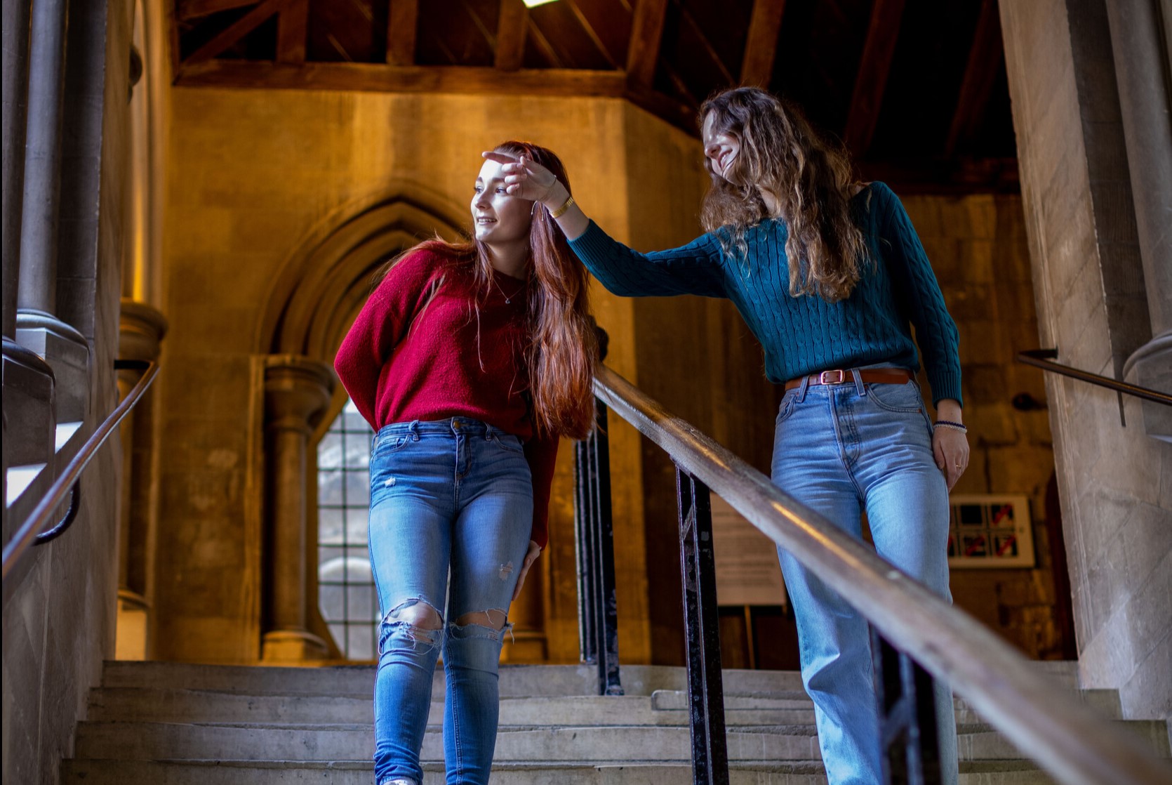 Two students walking down steps in Canterbury Cathedral
