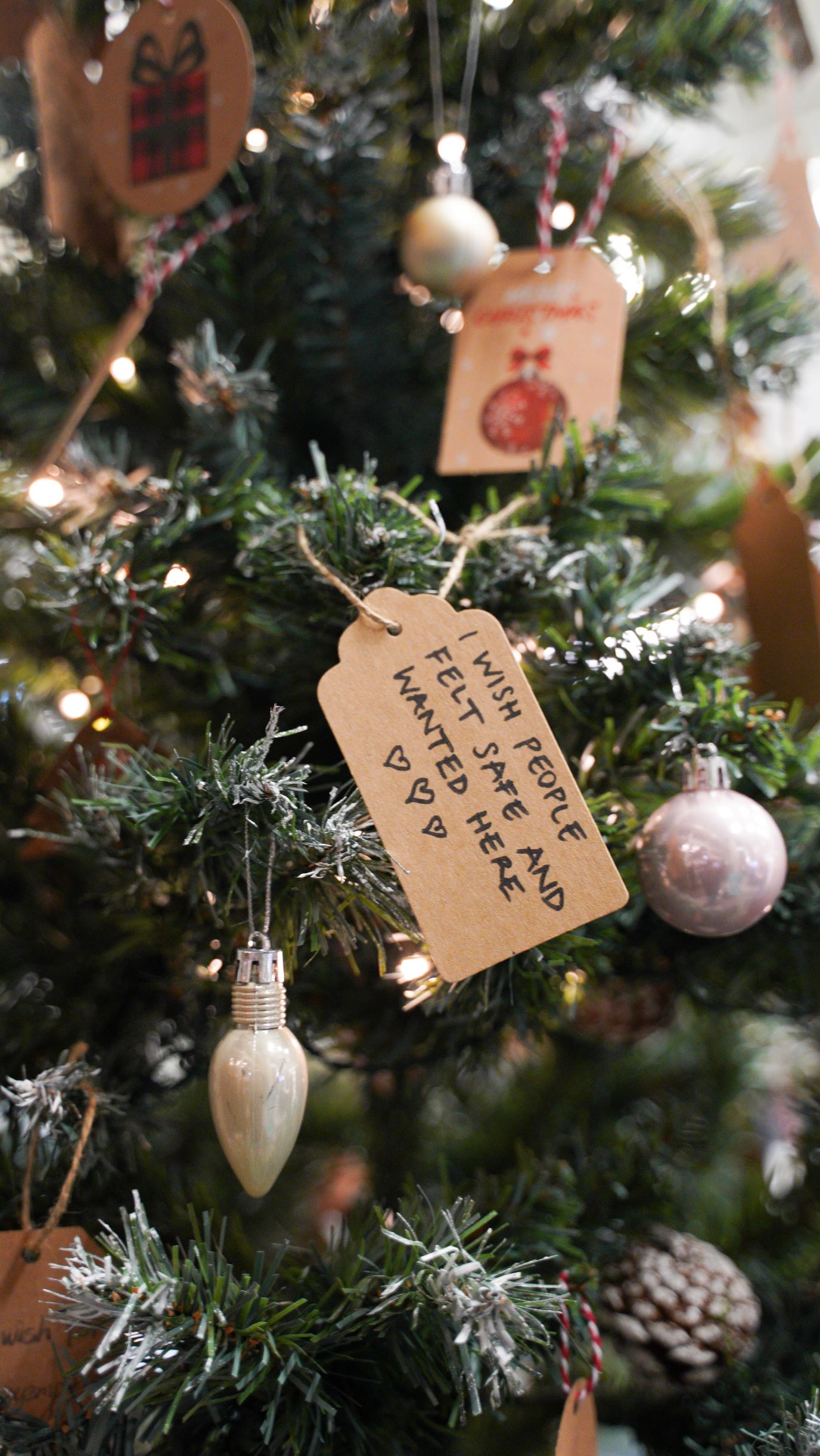 close up of Christmas tree with wish tag reading 'I wish all students felt safe and wanted here'