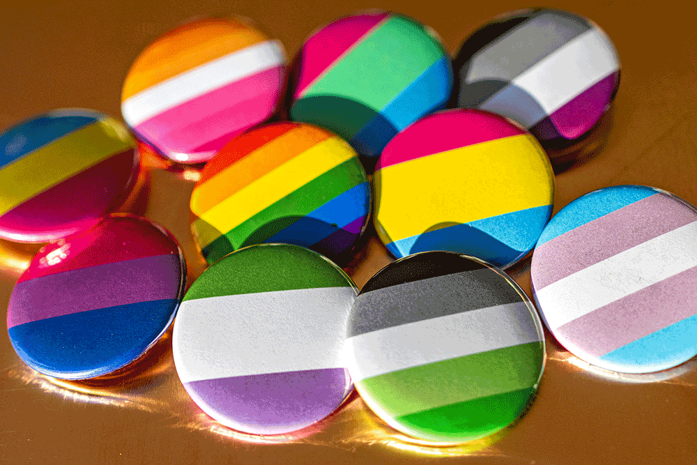 Badges representing different LGBTQ+ identities
