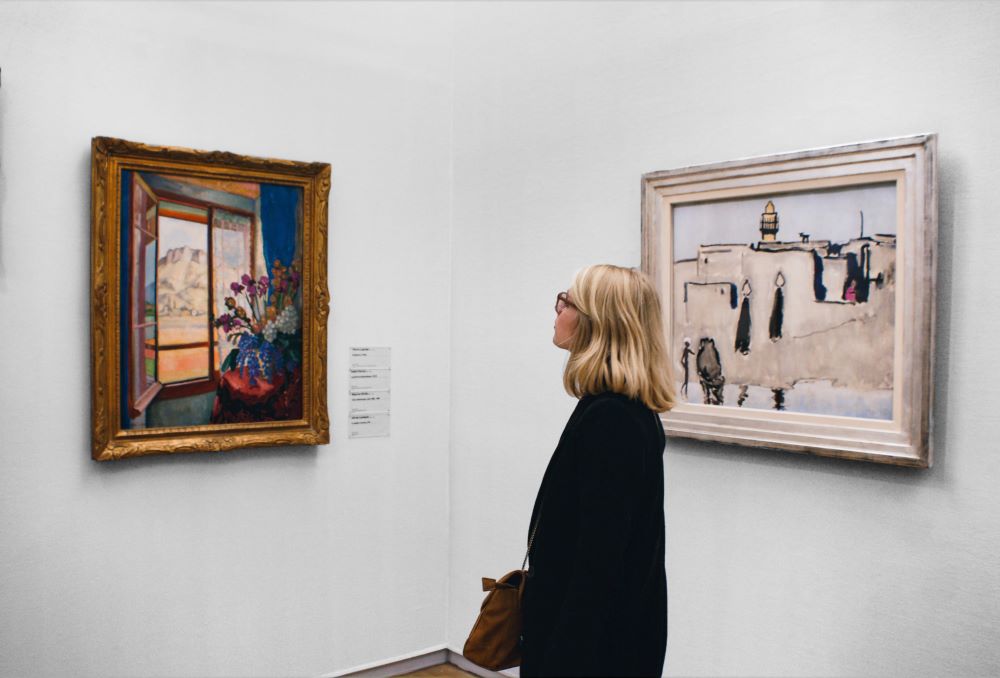 Woman looking at painting in gallery