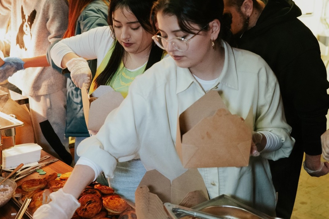 Students serving food at Iftar dinner