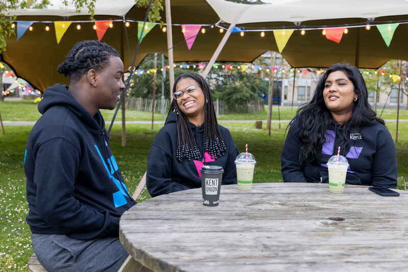 students laughing at picnic table