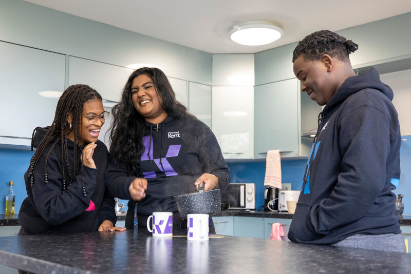 students talking in kitchen