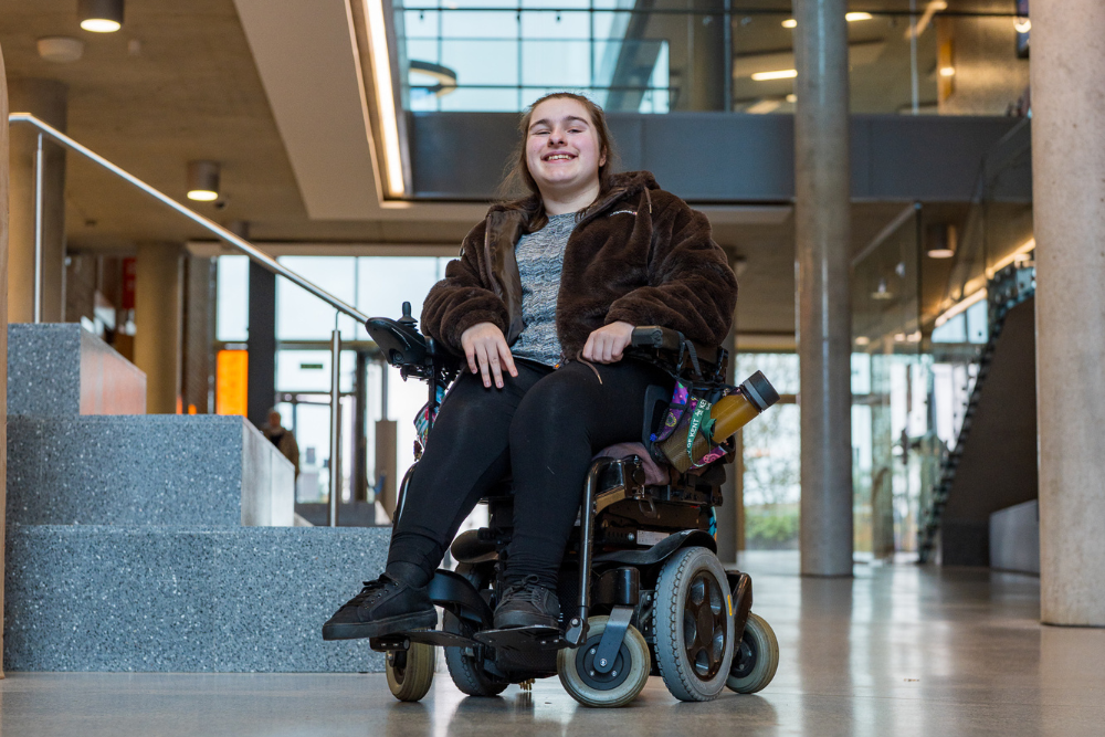 Gabby smiling in her wheelchair