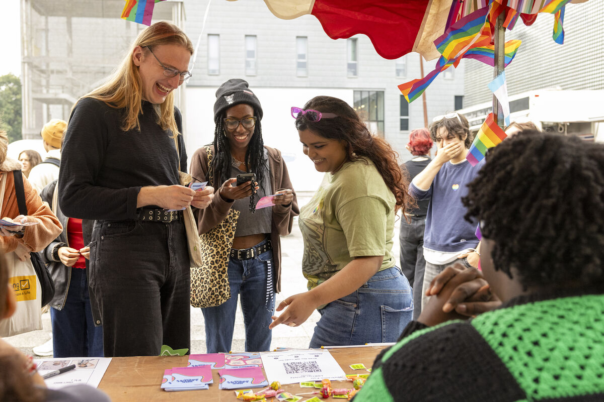 Students laughing at Welcome stall