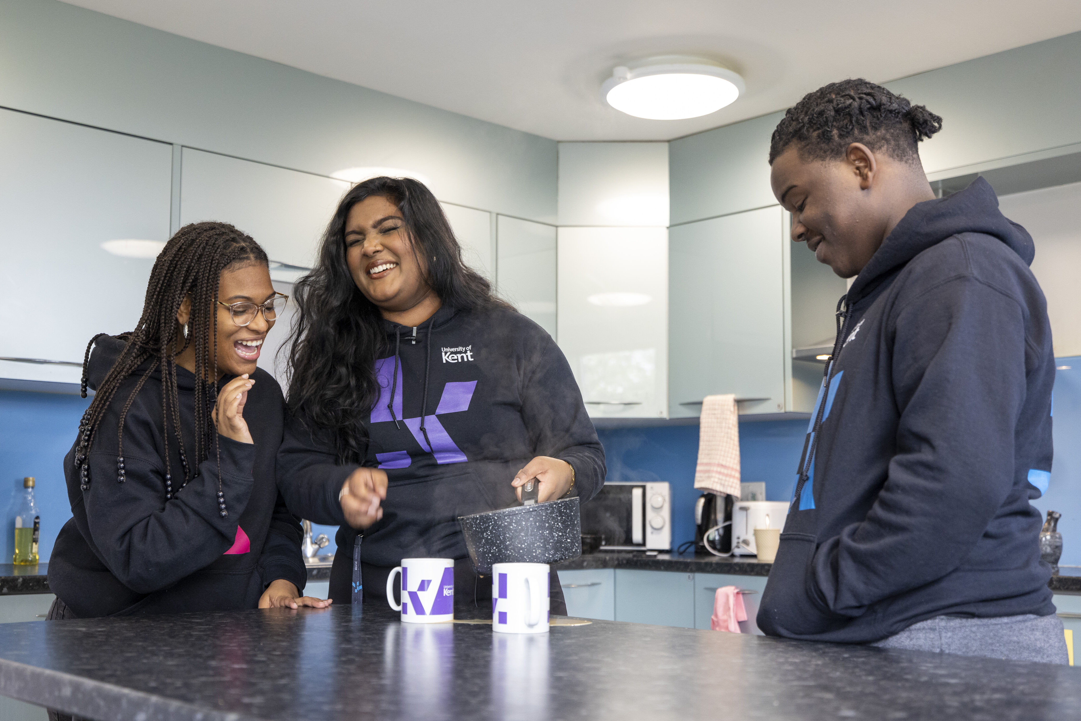 Students laughing together in student kitchen