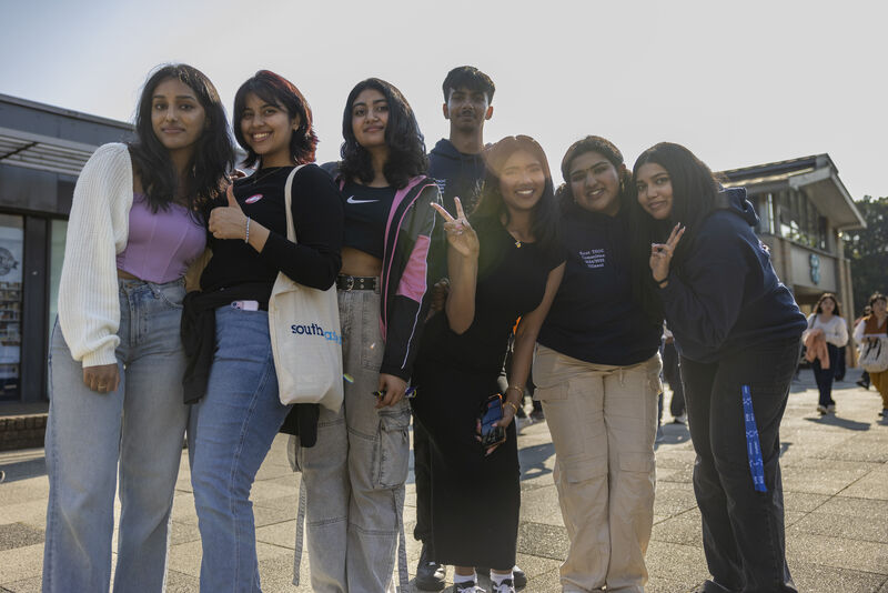 group of students smiling on campus