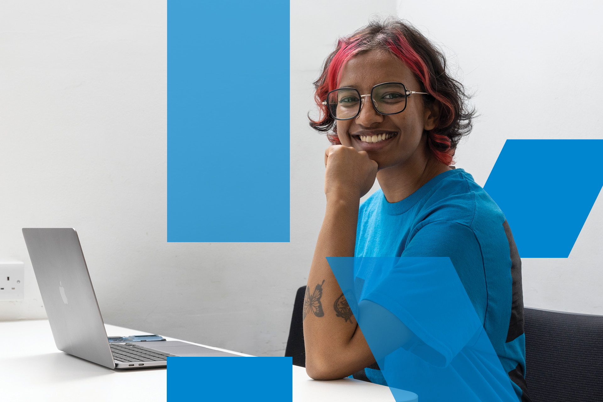 Student at laptop smiling