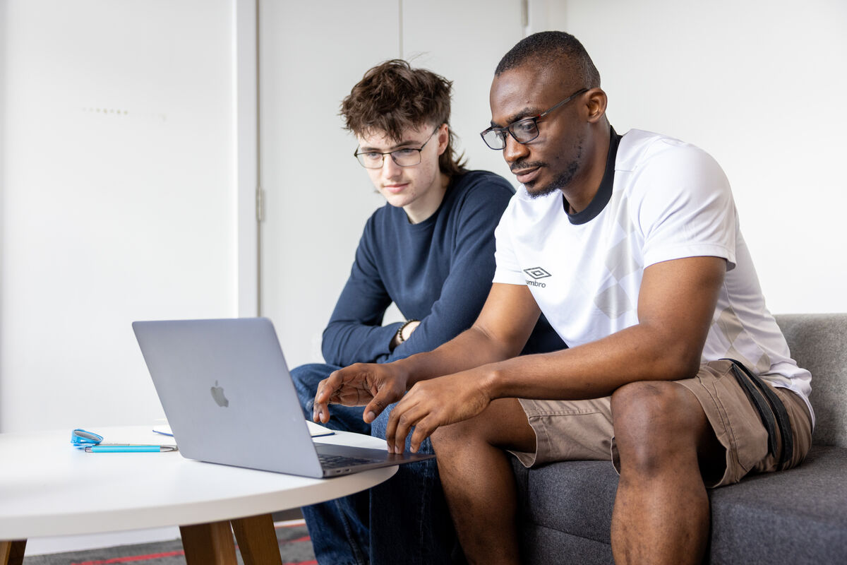 Students looking at laptop