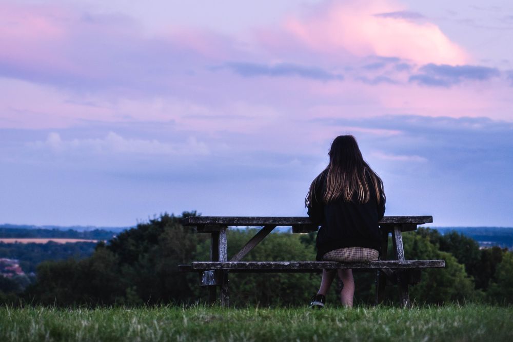 Student sat on bench looking away