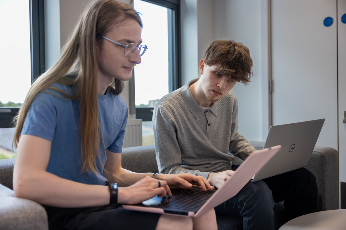 Students looking at laptops