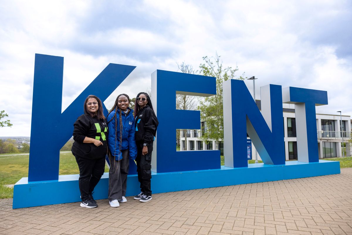 Students in front of large Kent letters