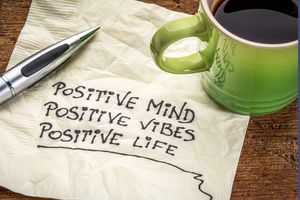 napkin with 'positive mind'; 'positive vibes'; 'positive life' written on it