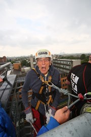 David Chadwick at the top of abseil tower pulls face