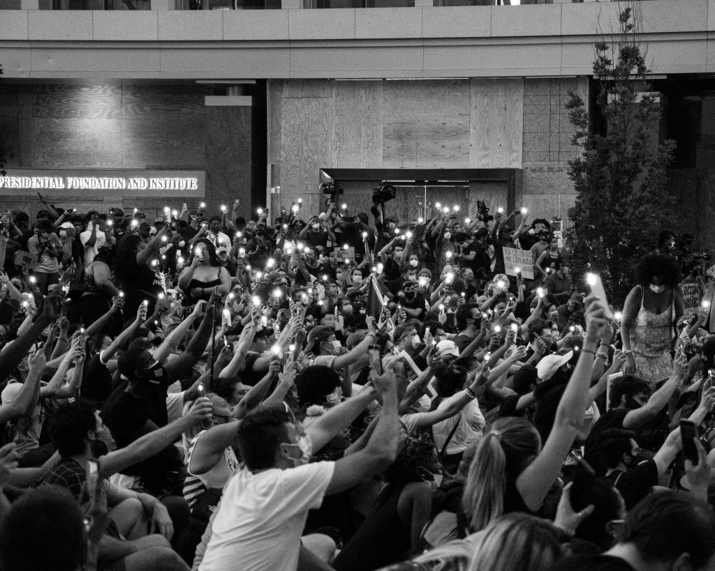 Black Lives Matter protesters holding smart phone torches