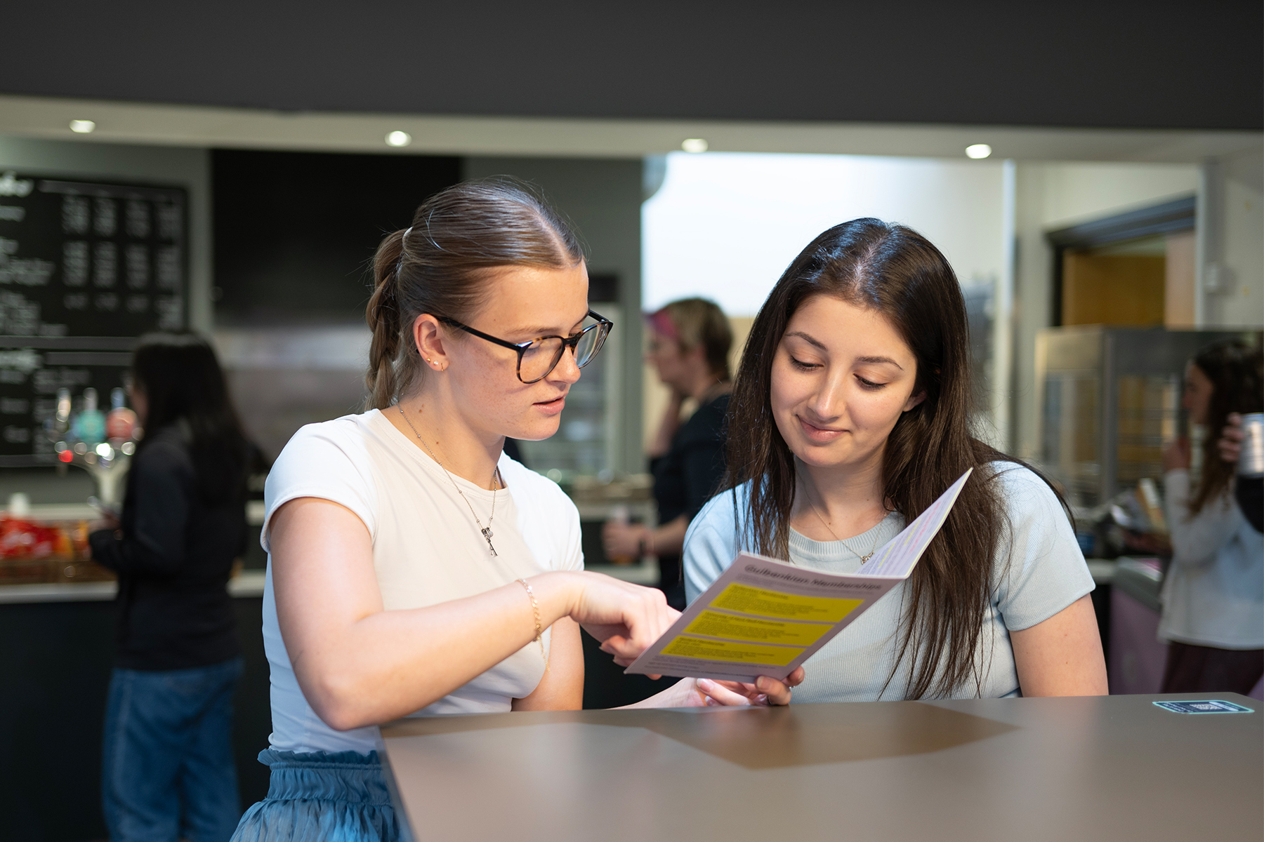 Two young customers reading a menu at the Gulbenkian Cafe