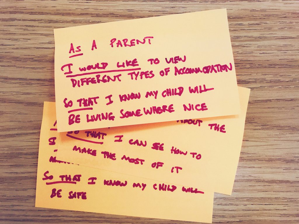 A pile of user stories written on orange post-it notes