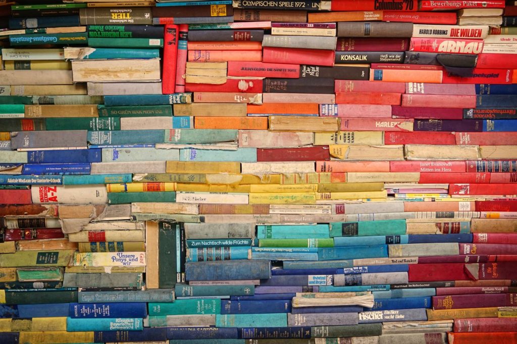 Pile of colourful books stacked on top of each other.